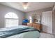Bright bedroom with a large window, ceiling fan, and traditional wood dresser at 2125 Floribanna St, North Port, FL 34287