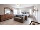 Cozy bedroom featuring tile floors, a ceiling fan, sitting area, and traditional furniture at 2125 Floribanna St, North Port, FL 34287