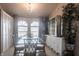 Dining room featuring a glass table with seating for six, a chandelier, and arched windows at 2125 Floribanna St, North Port, FL 34287