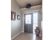 Inviting entryway featuring tile floors, a decorative mirror, a large vase, and a transom window at 2125 Floribanna St, North Port, FL 34287