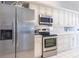 Modern kitchen with stainless steel appliances, plenty of counter space, and clean, white cabinetry at 2125 Floribanna St, North Port, FL 34287