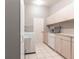 Well-equipped laundry room with washer, dryer, and ample storage at 2125 Floribanna St, North Port, FL 34287