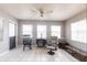 Cozy living area featuring a ceiling fan, seating, and natural light from multiple windows at 2125 Floribanna St, North Port, FL 34287