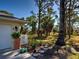 Landscaped backyard with stone pathway, planted beds, and surrounding trees at 237 Rotonda E Blvd, Rotonda West, FL 33947