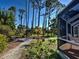 View of the backyard from the screened in porch, highlighting the garden and landscaping at 237 Rotonda E Blvd, Rotonda West, FL 33947