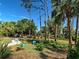 Secluded backyard featuring tropical trees, plants and a gravel path at 237 Rotonda E Blvd, Rotonda West, FL 33947