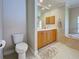 Bright bathroom features a toilet, a dual sink vanity, and a large soaking tub at 237 Rotonda E Blvd, Rotonda West, FL 33947