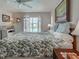 Spacious bedroom with a king bed, shuttered windows, and a view of the pool at 237 Rotonda E Blvd, Rotonda West, FL 33947