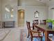 Bright dining room boasts a large wooden table, seating for six, and a view of the entrance at 237 Rotonda E Blvd, Rotonda West, FL 33947
