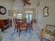 The dining room features a wood table with seating for six and a bright, decorative rug at 237 Rotonda E Blvd, Rotonda West, FL 33947