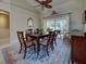Bright dining room boasts a large wooden table, seating for six, and a view of the pool and patio at 237 Rotonda E Blvd, Rotonda West, FL 33947