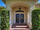 Inviting entryway with double glass doors, brick steps, and manicured bushes at 237 Rotonda E Blvd, Rotonda West, FL 33947