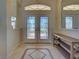 The front entrance has double doors with decorative glass and a tile floor with a custom design at 237 Rotonda E Blvd, Rotonda West, FL 33947