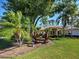 Inviting single-story home with lush landscaping and mature trees at 237 Rotonda E Blvd, Rotonda West, FL 33947