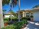 Well maintained single-story home with landscaped yard, mature trees and concrete walkway at 237 Rotonda E Blvd, Rotonda West, FL 33947