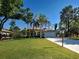 Charming single-story home with a long driveway, lush green lawn, and mature trees at 237 Rotonda E Blvd, Rotonda West, FL 33947