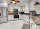 Bright kitchen featuring stainless steel appliances, granite countertops and white cabinetry at 237 Rotonda E Blvd, Rotonda West, FL 33947