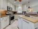 Bright kitchen featuring granite countertops, stainless steel appliances, and a movable island at 237 Rotonda E Blvd, Rotonda West, FL 33947