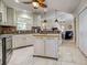A well-equipped kitchen has an island and plenty of cabinets, with access to the living room at 237 Rotonda E Blvd, Rotonda West, FL 33947