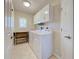 Functional laundry room with washer, dryer, sink, and built-in cabinets for storage at 237 Rotonda E Blvd, Rotonda West, FL 33947