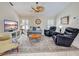 Comfortable living room with plush seating, a ceiling fan, and a flat-screen TV at 237 Rotonda E Blvd, Rotonda West, FL 33947
