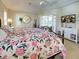 Comfortable primary bedroom features a ceiling fan, dresser with a TV, and views of the pool at 237 Rotonda E Blvd, Rotonda West, FL 33947