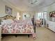 Comfortable primary bedroom boasts a ceiling fan, dresser, and a sitting chair with lots of natural light at 237 Rotonda E Blvd, Rotonda West, FL 33947