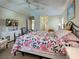 Comfortable primary bedroom boasts a ceiling fan, dresser, and a sitting chair with access to the bathroom at 237 Rotonda E Blvd, Rotonda West, FL 33947