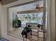 View from inside the home to the screened-in patio and pool area that has ample seating at 237 Rotonda E Blvd, Rotonda West, FL 33947
