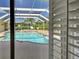 Covered pool with a cage and beautiful landscaping at 237 Rotonda E Blvd, Rotonda West, FL 33947