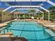Beautiful backyard pool with seating under a screened enclosure, excellent for relaxing and entertaining guests at 237 Rotonda E Blvd, Rotonda West, FL 33947