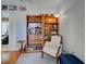 Cozy room featuring a vintage chair, wooden bookshelves, and a side table at 237 Rotonda E Blvd, Rotonda West, FL 33947