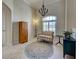 Comfortable sitting area with a striped loveseat, side tables, and natural light from a large window at 237 Rotonda E Blvd, Rotonda West, FL 33947