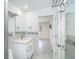 Well-lit bathroom featuring a glass shower, a vanity with granite countertop, and a tiled accent wall at 2700 N Beach Rd # A201, Englewood, FL 34223