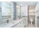 Bright bathroom featuring double sinks, granite countertops and decorative tile at 2700 N Beach Rd # A201, Englewood, FL 34223