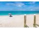 Quaint beach view with wooden access stairs, beach chair and umbrella at 2700 N Beach Rd # A201, Englewood, FL 34223