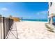 Beach view with brick paver patio, palm trees, and ocean access at 2700 N Beach Rd # A201, Englewood, FL 34223