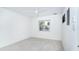 Bright bedroom with large window and ceiling fan with wood look floors at 2700 N Beach Rd # A201, Englewood, FL 34223