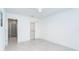 Bright bedroom with ensuite bathroom and closet featuring sleek gray flooring and modern ceiling fan at 2700 N Beach Rd # A201, Englewood, FL 34223