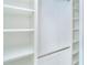 Bright walk-in closet with multiple shelving units and metal clothes hanger, offering ample storage at 2700 N Beach Rd # A201, Englewood, FL 34223