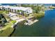 Aerial view of property with dock, boat lift, bay access, and waterfront seating area at 2700 N Beach Rd # A201, Englewood, FL 34223