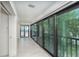 Hallway with beach and courtyard views, light walls, and tile floors at 2700 N Beach Rd # A201, Englewood, FL 34223