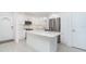 Bright kitchen featuring an island, stainless steel appliances, and white cabinetry at 2700 N Beach Rd # A201, Englewood, FL 34223