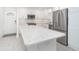 Bright kitchen featuring an island, stainless steel appliances, and white cabinetry at 2700 N Beach Rd # A201, Englewood, FL 34223