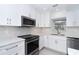 Modern kitchen with stainless steel appliances, white cabinetry and elegant countertops at 2700 N Beach Rd # A201, Englewood, FL 34223