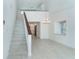 Open-concept living room with stairs that lead to the second floor at 2700 N Beach Rd # A201, Englewood, FL 34223