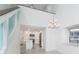 Bright open-concept space featuring a modern kitchen and dining area under high ceilings with chandelier at 2700 N Beach Rd # A201, Englewood, FL 34223
