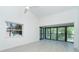 Bright living space with high ceilings, palm tree views, and large sliding doors to the outside at 2700 N Beach Rd # A201, Englewood, FL 34223