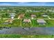 Aerial view of the property showcasing the expansive backyard, screened-in pool, and waterfront location at 29 Tournament Rd, Rotonda West, FL 33947