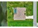 An aerial view of the home showcasing its well-manicured lawn, canal frontage and proximity to the neighborhood at 29 Tournament Rd, Rotonda West, FL 33947